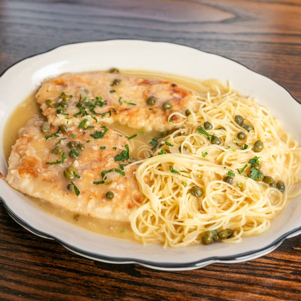 Chicken piccata with capers and parsley, served with angel hair pasta in a lemon butter sauce.