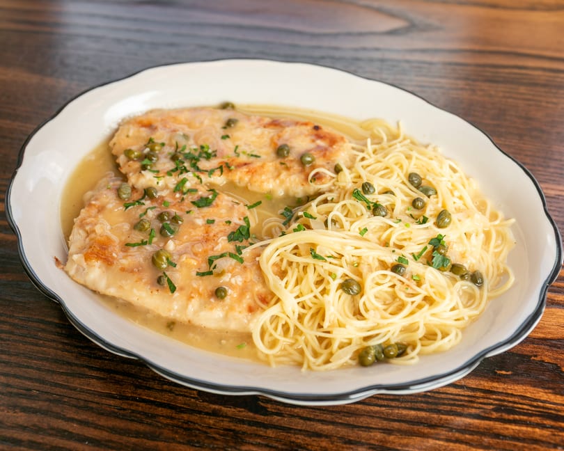 Chicken piccata with capers and parsley, served with angel hair pasta in a lemon butter sauce.